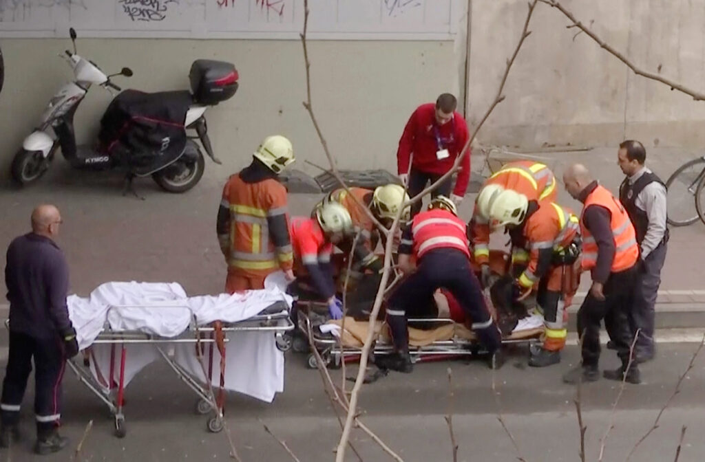 In this image made from video, emergency rescue workers stretcher an unidentified person at the site of an explosion at a metro station in Brussels, Belgium, March 22, 2016. Explosions rocked the Brussels airport and the subway system Tuesday, just days after the main suspect in the November Paris attacks was arrested in the city, police said.(APTN via AP)