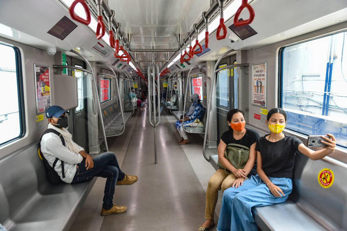 a group of people sitting at a train station: Passengers inside a metro as the service resumed after unlocking process of Covid-19 lockdown began in a phased manner in Lucknow. (PTI Photo)